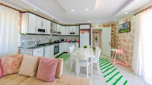 a kitchen and a living room with a couch and a table at Villa atılgan in Kaş
