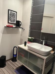 a bathroom with a sink and a mirror at Chambre d'hôtes Le Cadran des Chauvelles in Nevers +32 photos