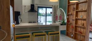 a kitchen with a counter with stools in it at Antonio's River View in Cochin