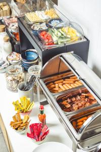 a buffet with many different types of food on a table at Florin Apart Hotel in Budapest +60 photos