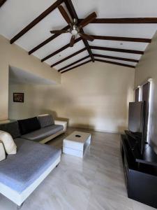 a living room with a couch and a ceiling fan at Casa de Playa en Puerta del Mar in Rosarito