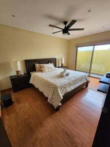 a bedroom with a bed and a ceiling fan at Casa de Playa en Puerta del Mar in Rosarito +61 photos