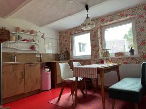 a kitchen with a table and chairs and a window at Ferienhaus Lotte Havelland in Götz