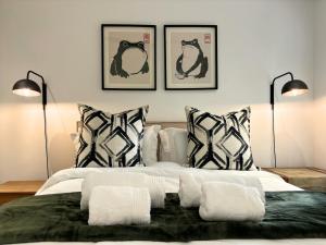 a bedroom with a bed with black and white pillows at The Paarl Grand in Paarl
