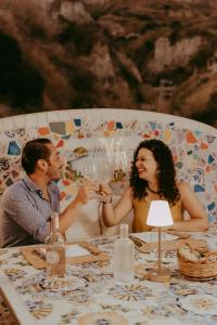 a man and a woman sitting at a table at Hotel Ferdinando Beach & Thermal Spa in Ischia