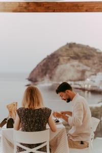 a man and a woman sitting at a table at Hotel Ferdinando Beach & Thermal Spa in Ischia