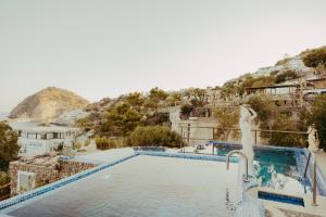 a pool at a resort with a view of a town at Hotel Ferdinando Beach & Thermal Spa in Ischia