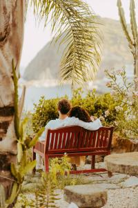 a couple sitting on a bench looking at the water at Hotel Ferdinando Beach & Thermal Spa in Ischia