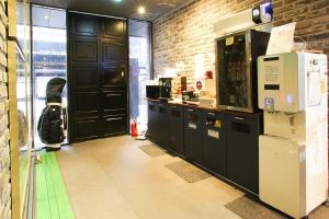 a room with black cabinets and a brick wall at Hotel Avant in Cheonan