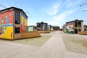 a group of buildings with graffiti on them at Rent A Holiday Home In Fun Art Fun In Blokhus! in Pandrup