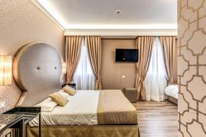 Postel nebo postele na pokoji v ubytování Hotel Belle Arti