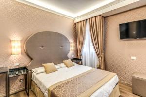 Postel nebo postele na pokoji v ubytování Hotel Belle Arti