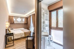 Postel nebo postele na pokoji v ubytování Hotel Belle Arti