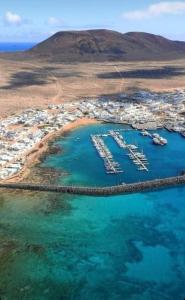 an aerial view of a harbor with boats in the water at Apartamento La Graciosa- Casa Lapitas in Caleta de Sebo