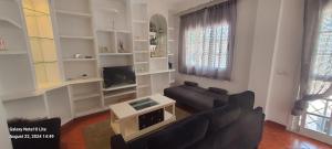 a living room with a couch and a tv at UF holiday Villa in Málaga