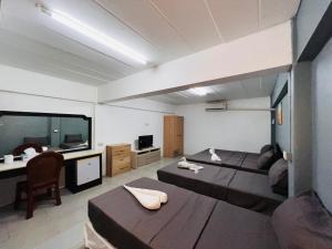 a large room with a large bed and a desk at Patong Adventure Hostel in Patong Beach
