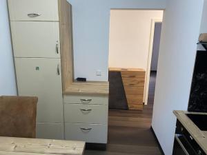 a kitchen with white cabinets and a mirror at 1 Zimmer Ferienwohnung in Essen in Essen