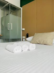 a bed with three towels on top of it at L'Hôtel Bristol in Caen +21 photos