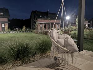 a chair sitting on a porch at night at Norda Loft in Dębki