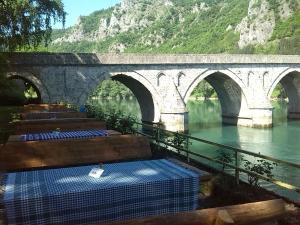 a bridge over a river with a bunch of beds at Hotel Višegrad in Višegrad