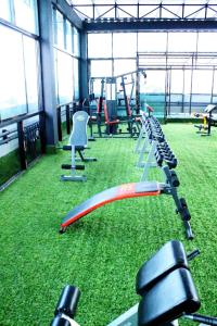 a gym with a bunch of exercise equipment on the grass at Rod Fai Fah Apartment in Bangkok