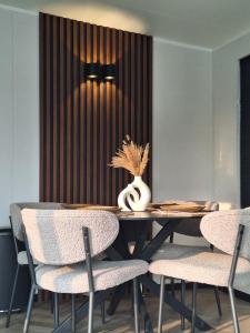 a dining room with a table and chairs at 'Relax Lodge Sea' - Wellness lodge in Zeeland - Private Sauna - Airco - Garden - Outdoor Swimming pool - Free Wifi, Towels & Bed linen in Heinkensand
