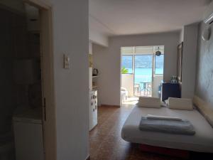 a living room with a bed and a view of the ocean at Bay View Apartment in Herceg-Novi +18 photos