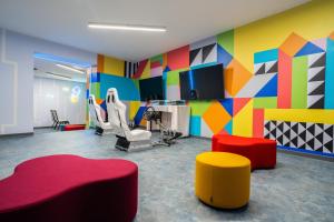a salon with a colorful room with chairs and tables at Amadria Park Grand Hotel 4 Opatijska Cvijeta in Opatija