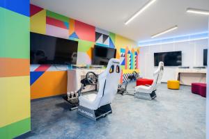 a room with two chairs and a room with colorful walls at Amadria Park Grand Hotel 4 Opatijska Cvijeta in Opatija