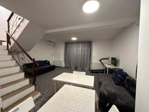 a living room with a staircase and a couch at JoyGate entire villa in Otopeni