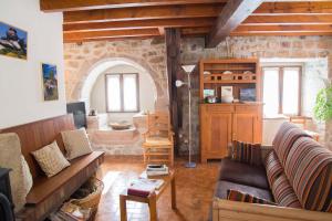 a living room with a couch and a table at Gite bienvenue a couffinet in Sainte-Colombe-de-Peyre