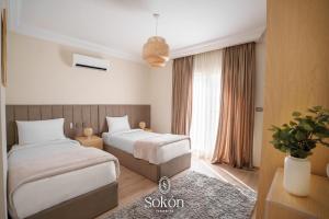 Postel nebo postele na pokoji v ubytování Sokón Residence -Cairo - New Cairo -Rehab city - U33 + 37 fotografií