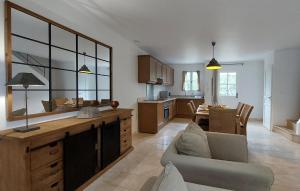 a kitchen and living room with a couch and a table at Cozy Home In Saint-Laurent-De-La-Ca With Wifi in Saint-Laurent-de-la-Cabrerisse +33 photos