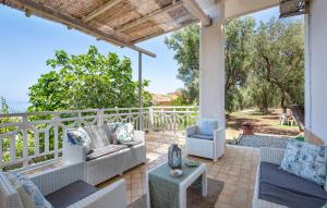 an outdoor patio with couches and a table and chairs at Panoramic House in Palmi