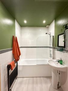 a bathroom with a white tub and a sink at 2 Bed - 2 Bath - Duplex Apartment next to LBU-Headingley Centre-YCC Arena-Families-Relocators in Meanwood