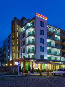 a hotel building with a car parked in front of it at Central Plaza in Pomorie