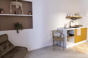 a living room with a couch and a kitchen at San Nicolicchio al Borgo in Taranto +22 photos