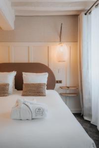 Ένα ή περισσότερα κρεβάτια σε δωμάτιο στο Hôtel Henry II Beaune Centre
