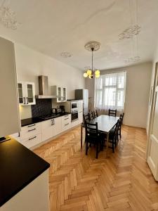 a kitchen and dining room with a table and chairs at Prague Central Exclusive Apartments in Prague