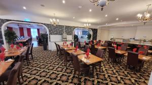 a dining room with wooden tables and chairs at Heathlands Hotel in Bournemouth