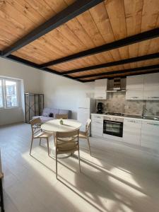 a kitchen and dining room with a table and chairs at Luma Holiday Homes in Mondragone