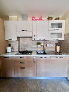 a kitchen with white cabinets and a stove top oven at I piedi nell'acqua in Finale Ligure