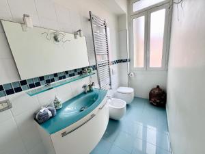 a bathroom with a blue sink and a toilet at I piedi nell'acqua in Finale Ligure