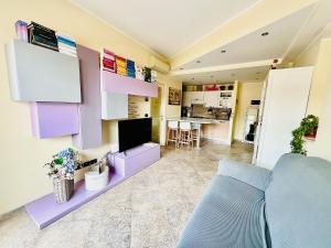 a living room with a couch and a tv at I piedi nell'acqua in Finale Ligure +7 photos