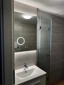 a bathroom with a sink and a mirror at Waldhotel Wandlitz in Wandlitz
