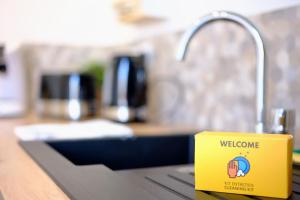 a yellow mug sitting on a counter next to a sink at Rouen - Bienvenue chez Alice in Rouen
