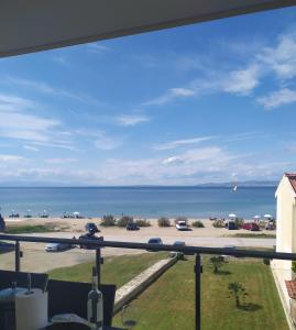 a view of the ocean from a balcony at Luxury apartment in front of the Sea in Agia Triada in Agia Triada