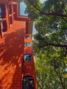 an orange building with trees in front of it at Kaibu Courtyard Superior Apartment, Changjiang Cable Car Nanbin Road, Chongqing in Chongqing
