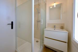 a bathroom with a glass shower and a sink at Rouen - Le Cocon de Gaëlle in Rouen +23 photos