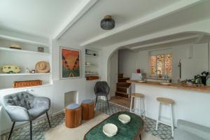 a kitchen and living room with a table and chairs at La Maison de Poupées - Plage à Pied - Hyper Centre in Villerville
